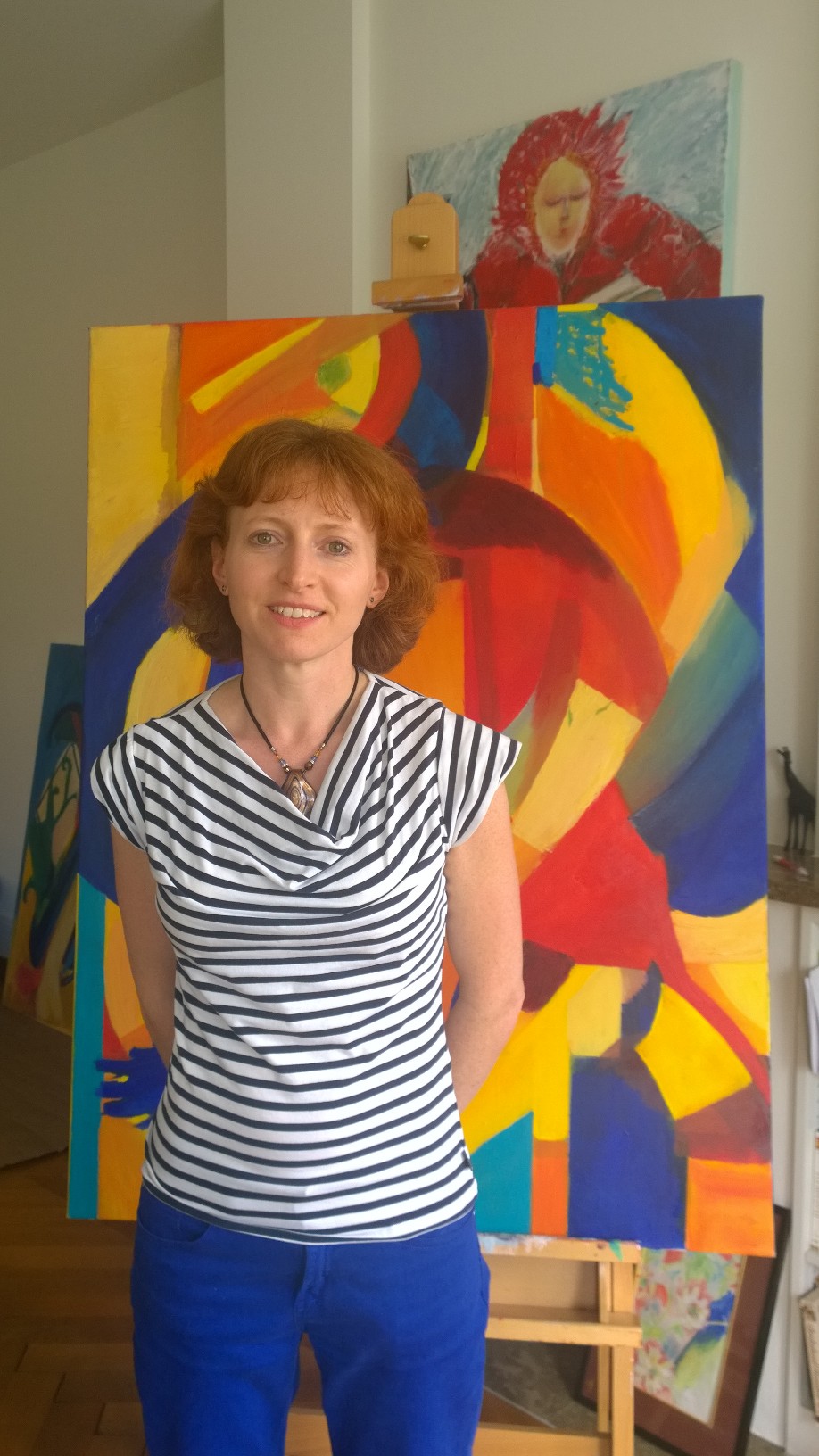 Antonia Weetman standing in front of her painting